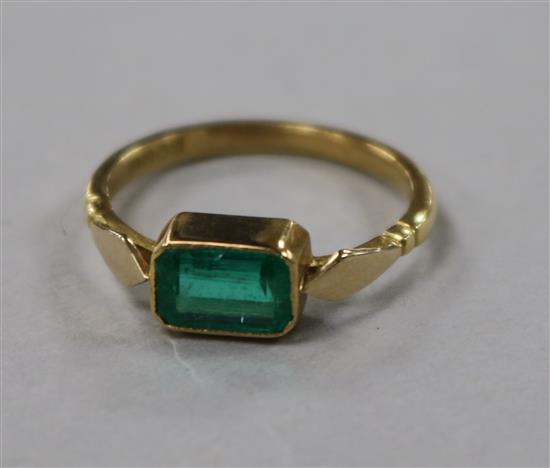 A late 1930s 18ct gold and collet set emerald ring, size K.